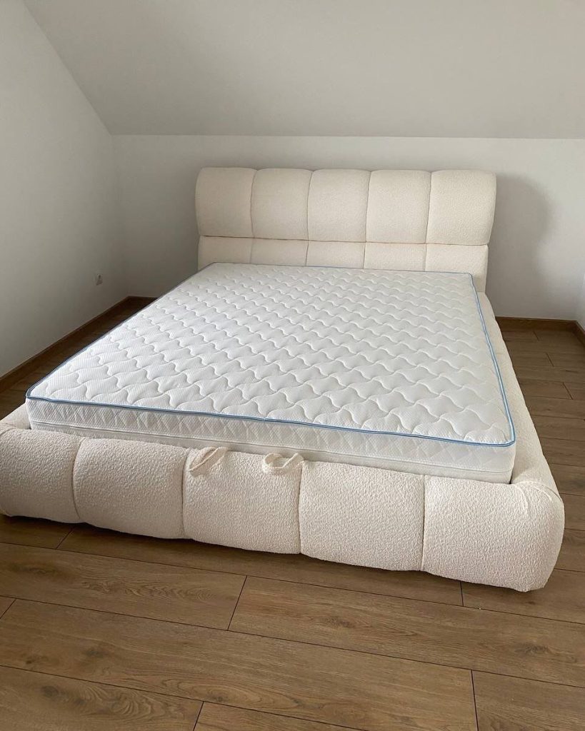 modern double upholstered bed in attic interior